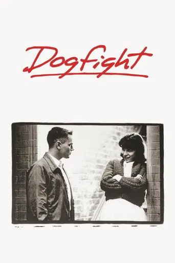 The poster features a dramatic black-and-white scene with two characters in a tense moment, one holding a gun while the other stands nearby. The bold red title "Dogfight" dominates the top, evoking a sense of action and conflict. The muted tones and dramatic composition suggest a gritty, high-sta...