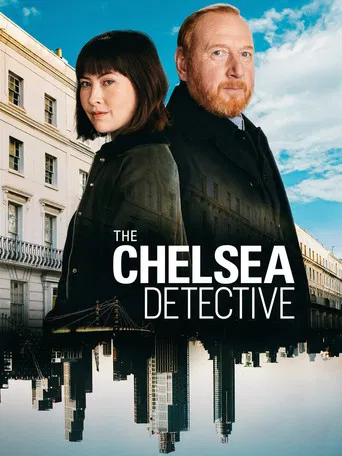 The Chelsea Detective poster features a striking urban scene with two detectives in formal attire against a backdrop of classic London architecture. The cool blue tones of the sky contrast with the warm tones of the city buildings, creating a dramatic and mysterious atmosphere. The reflective wat...