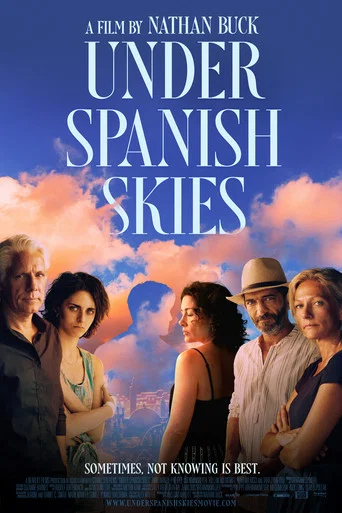 The poster features a group of five diverse people standing against a vibrant sky filled with pink and orange clouds. The title "Under Spanish Skies" is prominently displayed in bold white letters, evoking a sense of adventure and cultural exploration. The overall mood is warm and inviting, sugge...