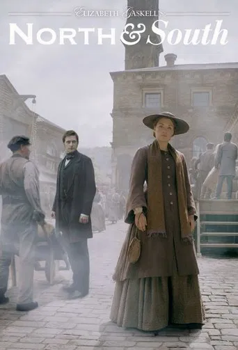 This poster depicts a historical scene from "North & South," featuring a man in a wide-brimmed hat and coat standing in the foreground, while another man in a dark suit stands behind him. The muted, sepia-toned palette evokes a sense of nostalgia and drama, with cobblestone streets and period clo...