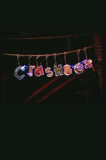 A vibrant "Crashbox" poster captures the chaotic energy of a late-night comedy show. The letters are illuminated in colorful, dynamic hues against a dark background, evoking excitement and fun. The poster suggests a lively, entertaining experience for viewers.