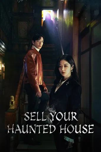 The poster features two characters in a dimly lit, eerie house interior. The warm glow from above contrasts with the cool tones of the room, creating a suspenseful and mysterious atmosphere. The title "Sell Your Haunted House" is prominently displayed in bold, white letters at the bottom.