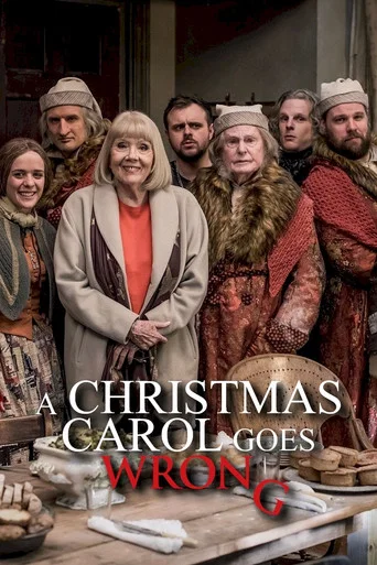 The poster features a group of people dressed in period costumes, suggesting a historical setting. The warm tones of the clothing and the festive atmosphere create a cozy mood. The title "A Christmas Carol Goes Wrong" is prominently displayed, hinting at a humorous take on the classic story.