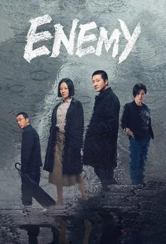 The poster features four characters in a somber, moody scene with muted tones and a dark, reflective surface. The title "Enemy" is prominently displayed at the top, suggesting a tense, dramatic narrative.