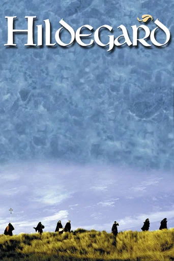 The poster features silhouetted figures standing on a grassy hill under a vast, ethereal blue sky. The title "Hildegard" is elegantly displayed in white serif font at the top. The mood is serene and mysterious, evoking a sense of timeless peace and wonder.