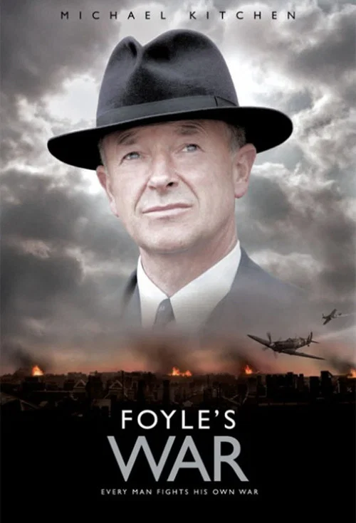 The poster features a stern, weathered man in a black hat and tan suit, exuding authority and resilience. The muted sepia tones and vintage car background evoke a gritty, historical atmosphere. The bold, white title "FOYLE'S WAR" anchors the image, suggesting a dramatic narrative of conflict and ...