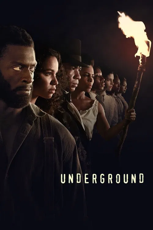 The poster features a group of men in dimly lit, shadowy environments, creating a mysterious and tense atmosphere. The warm glow of a torch illuminates their faces, casting dramatic shadows and emphasizing their serious expressions. The dark background enhances the suspenseful mood, while the tit...