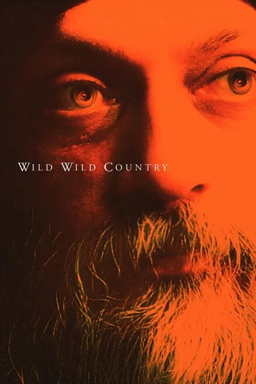 The poster features a close-up of a man with a beard and intense eyes, bathed in warm orange hues. The text "Wild Wild Country" is subtly placed in the center. The mood is mysterious and evocative, suggesting themes of nature, isolation, and introspection.