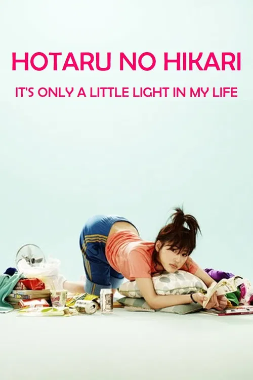 The poster features a young woman with dark hair tied in a bun, lying on her stomach on a white surface. She wears an orange shirt and blue jeans, with her hands resting on her knees. Surrounding her are various colorful objects, including a green bag, a red box, and a purple container, creating ...
