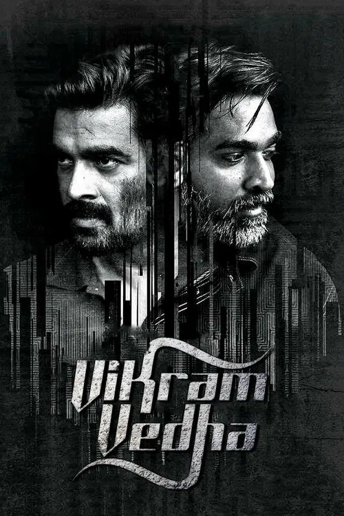 This movie poster features two men with intense expressions against a dark, textured background. The title "Vikram Vedha" is prominently displayed in stylized lettering, suggesting a dramatic and intense narrative. The monochromatic color scheme enhances the gritty and serious tone of the film.