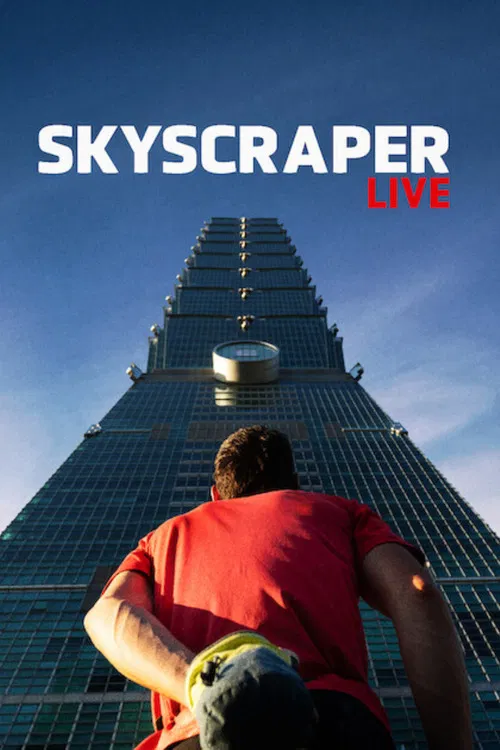 A man in a red shirt stands before a towering skyscraper, evoking a sense of ambition and urban exploration. The vibrant red shirt contrasts with the blue sky and the gleaming glass facade, creating a dynamic and visually striking image.
