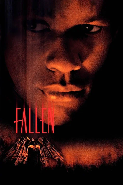 The poster features a close-up of a man's face, illuminated by a warm, reddish glow that casts deep shadows. The title "Fallen" is prominently displayed in bold, red letters against the dark background. The overall mood is somber and mysterious, evoking a sense of tragedy and suspense.