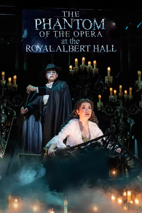 The poster features a white opera mask with dark, mysterious eyes, evoking the classic Phantom of the Opera. The Royal Albert Hall is depicted in the background, bathed in warm, golden light. The overall mood is mysterious and theatrical, with a blend of cool blues and warm tones.