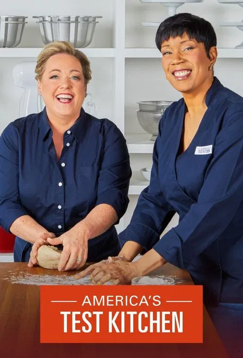 Two women in navy uniforms stand behind a wooden counter, smiling warmly at the camera. The warm lighting and inviting atmosphere suggest a friendly, approachable cooking show. The vibrant red banner at the bottom reinforces the show's identity.